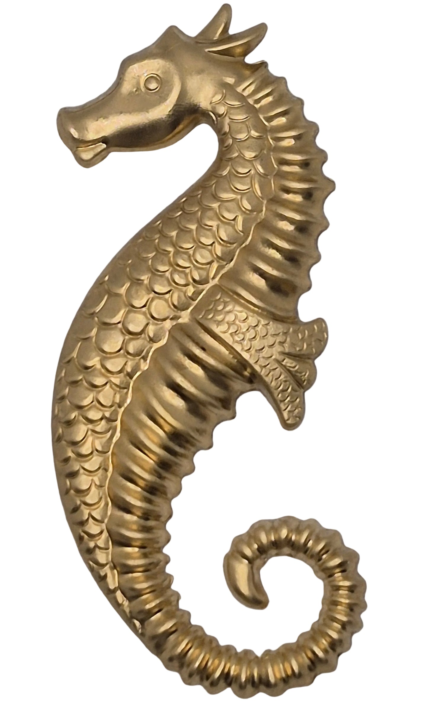 Brass seahorse decorative item on a gray background